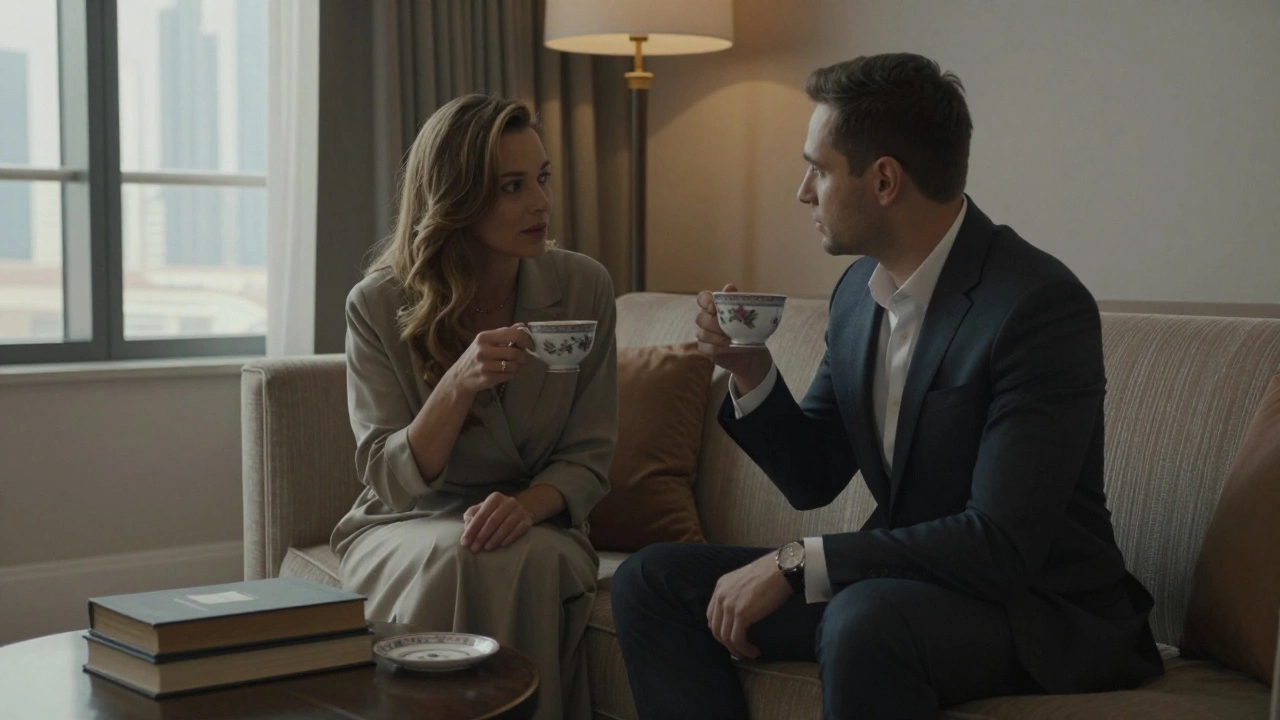 A man and woman share tea in a luxurious Dubai hotel room, books and skyline visible in the background.